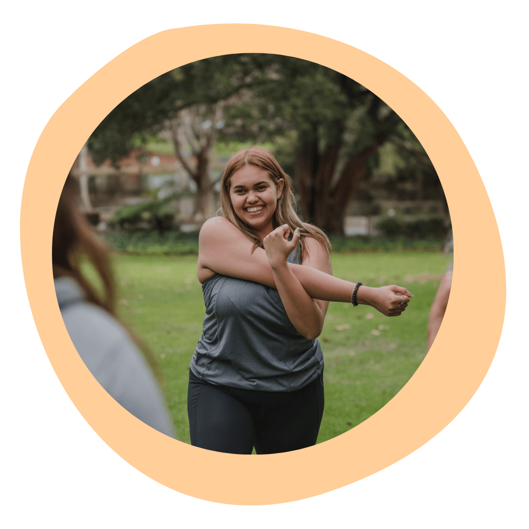 An image of a young Aboriginal woman warming up for exercise in the park