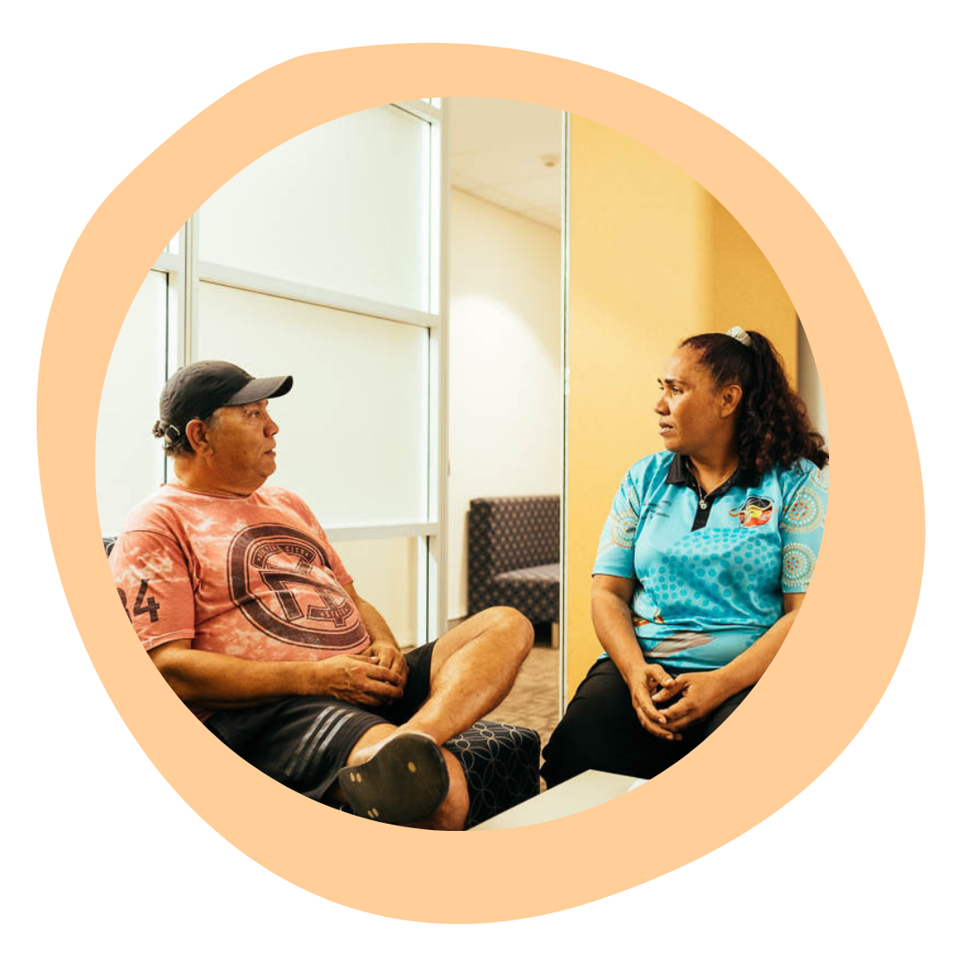 A female Aboriginal Health Worker speaks with one of her male clients